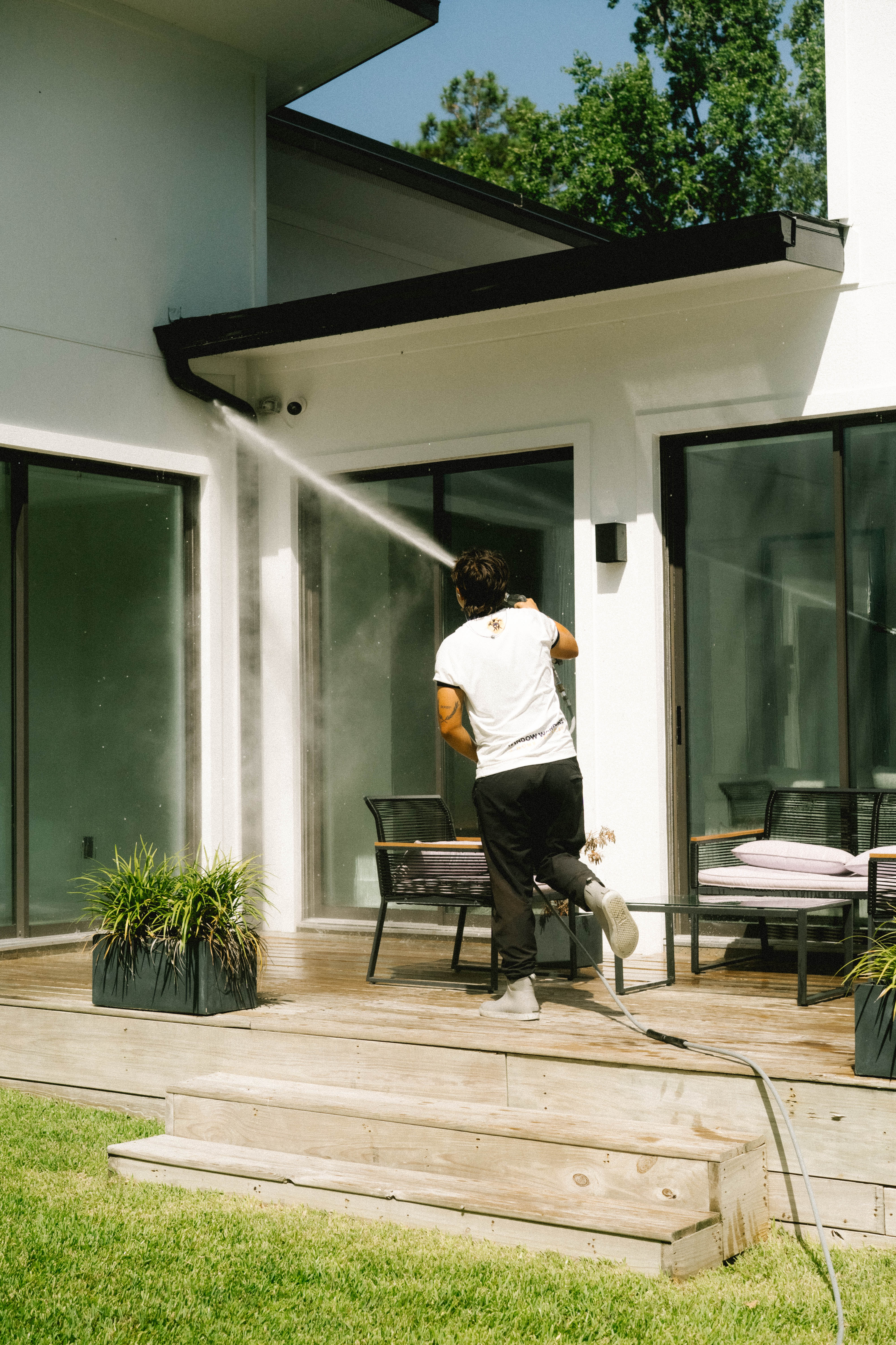 Pressure washing a covered patio and roofline