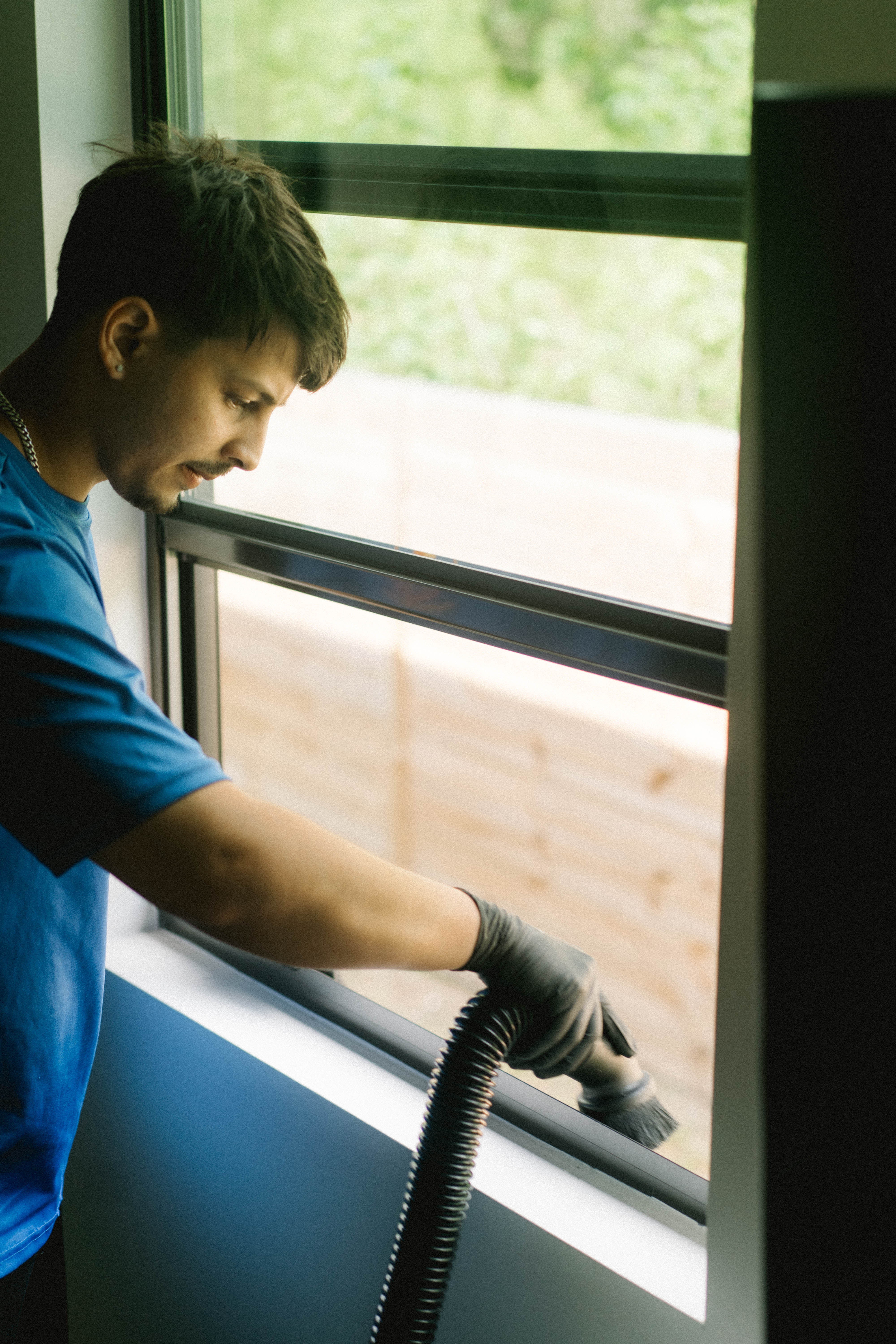 Vacuuming built-up debris from a window track