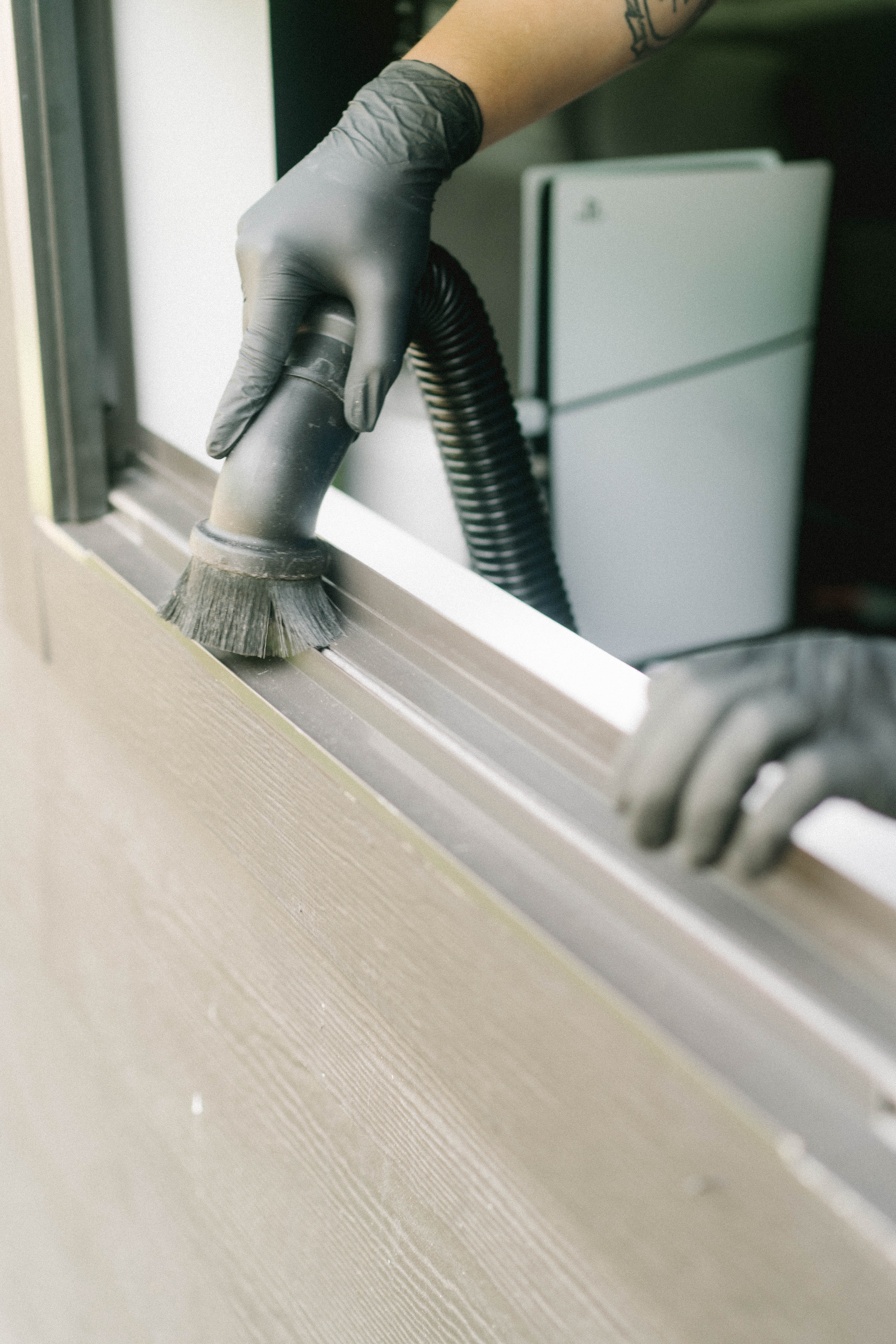 Close-up of a window track being detailed by hand
