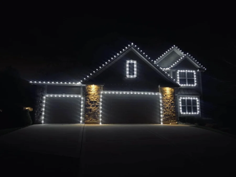 Professionally installed holiday lights on a Houston-area home at night