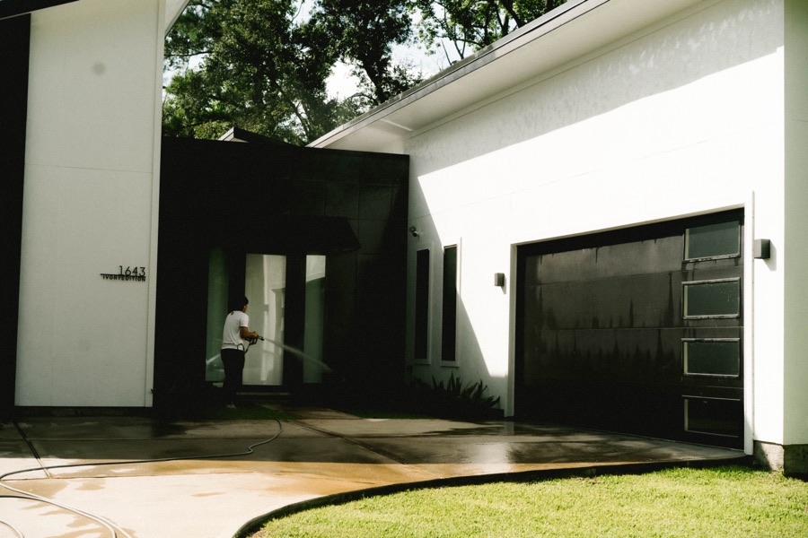 Pressure washing a modern home driveway