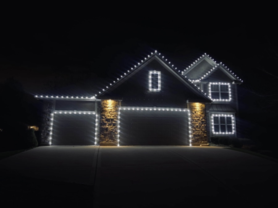 Professionally installed holiday lights on a Houston-area home at night