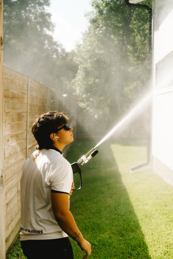 Soft washing service being applied to a home exterior in Houston, TX